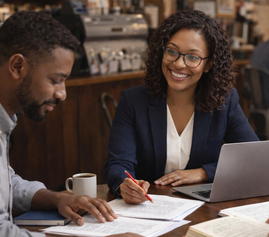 Photo of keyboard and glasses Tools for writing, like a notebook, pen, laptop, glasses, and headphones